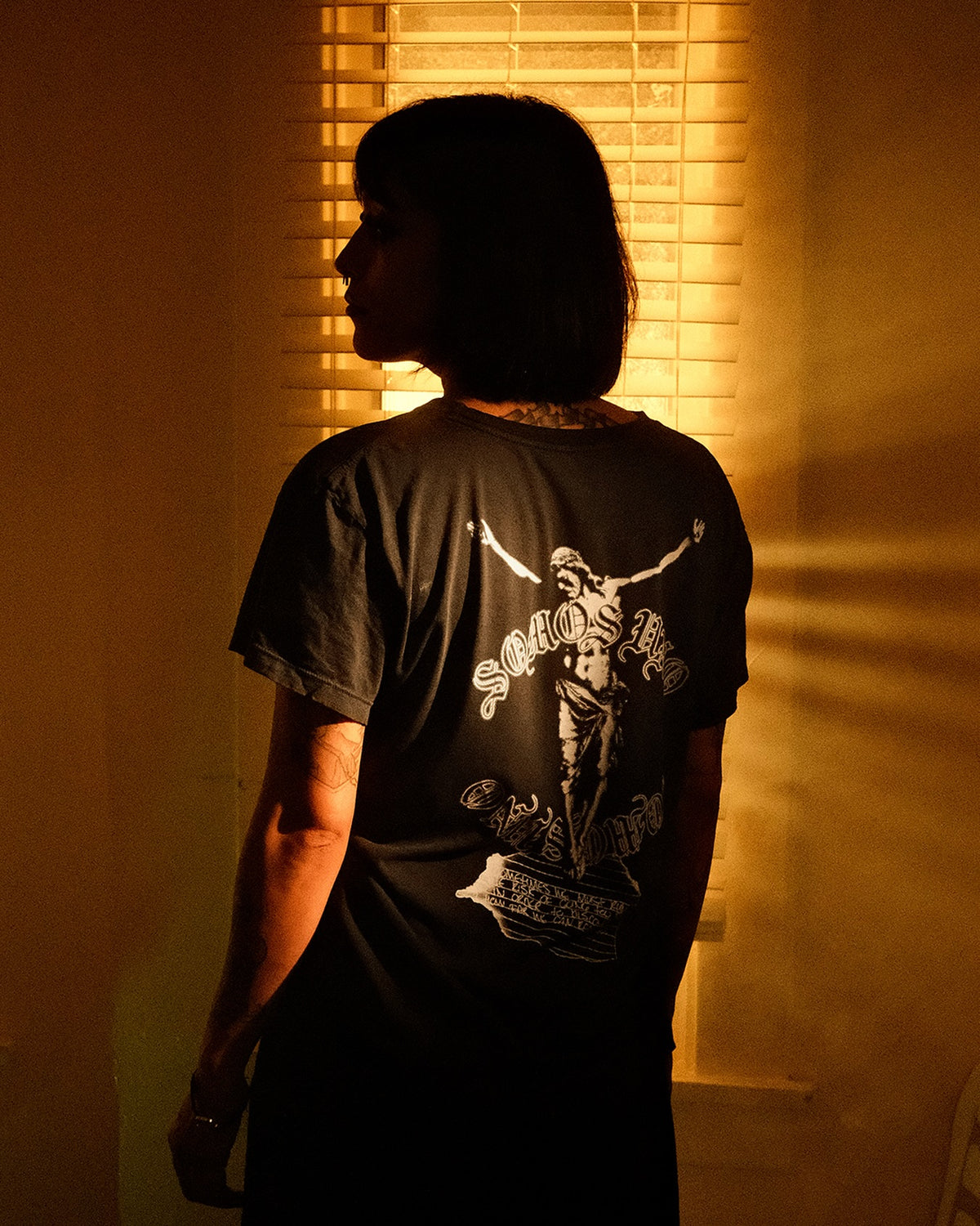 Campaign: the back print of the Jesus Pinta Letter tee in window light